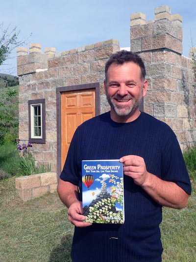 Tom Elpel holding Green Prosperity in front of guest castle.